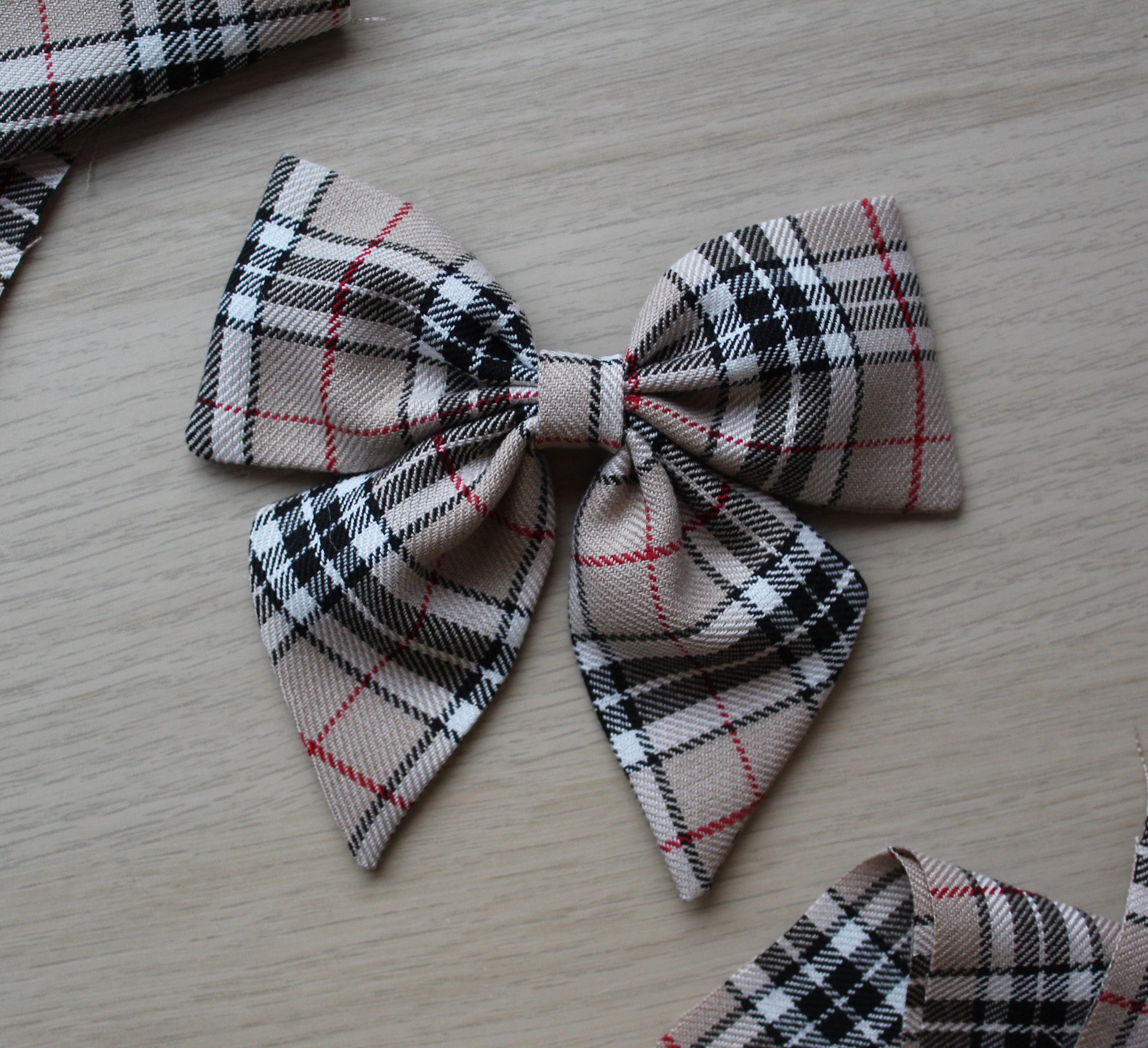 Beige and black plaid tartan hair bow