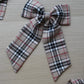 Beige and black plaid tartan hair bow