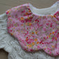 Frill baby bib with pink ditsy flowers