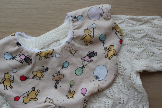 Scallop bib with winnie and piglet pattern