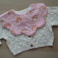 Scallop baby bib with rainbow polka dot design