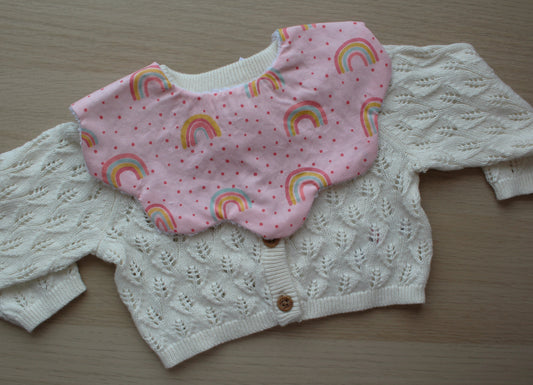 Scallop baby bib with rainbow polka dot design