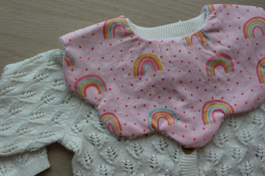 Rainbow polka dot pattern baby bib with scallop edges