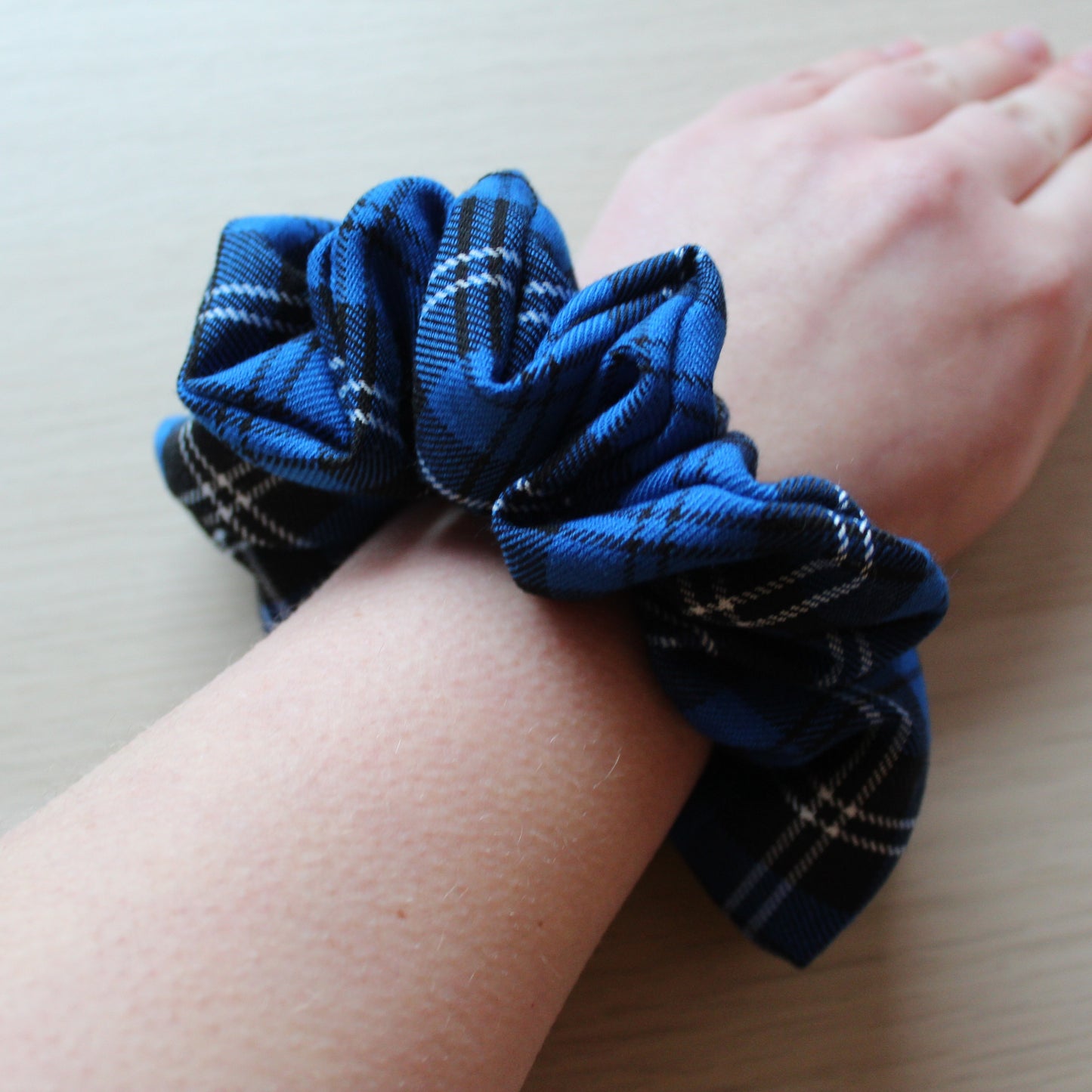 Oversized blue tartan hair scrunchie on wrist