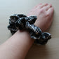 Oversized black and white tartan plaid hair scrunchie on wrist