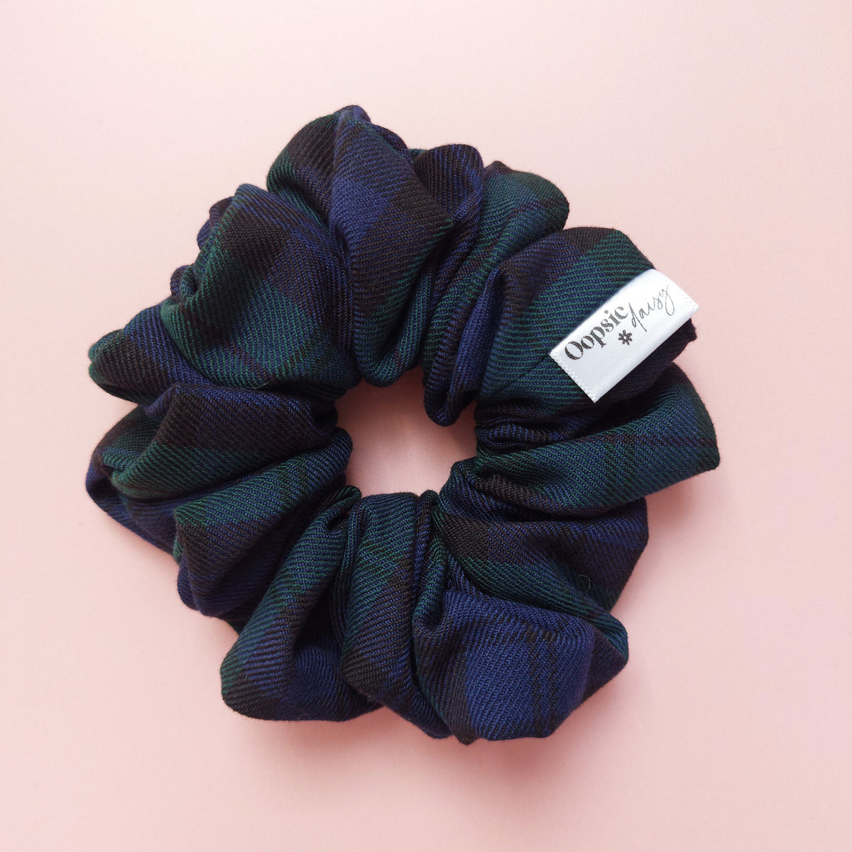 Oversized Black Watch tartan hair scrunchie made from dark green and navy tartan fabric. 