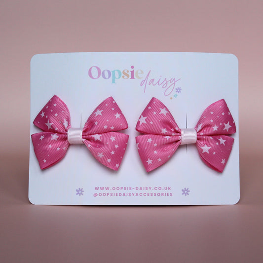 Pair hair bows in pink with small white stars