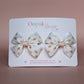 Cream hair bows with subtle orange, pink and yellow little sun pattern
