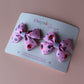 Pink hair bows with red ladybirds and tiny purple flowers