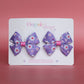 Pink and purple daisy bow hair clips