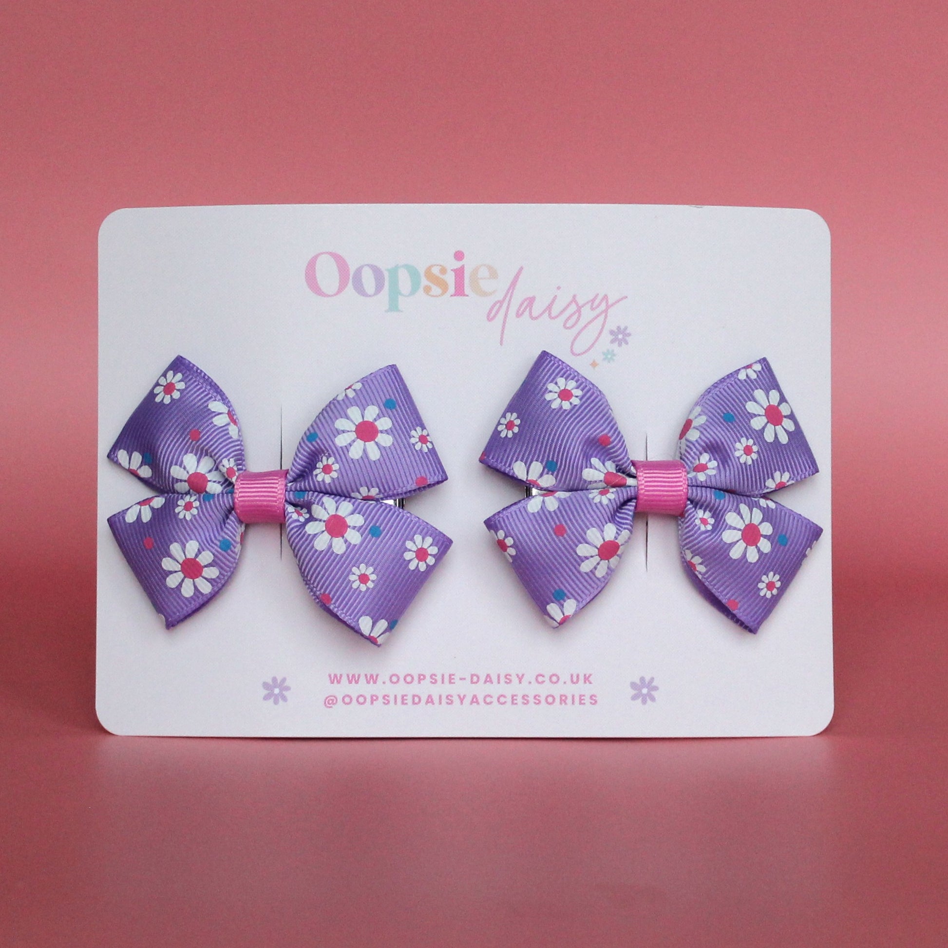 Pink and purple daisy bow hair clips