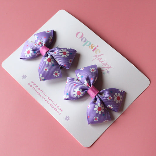 Pink and purple daisy bow hair clips