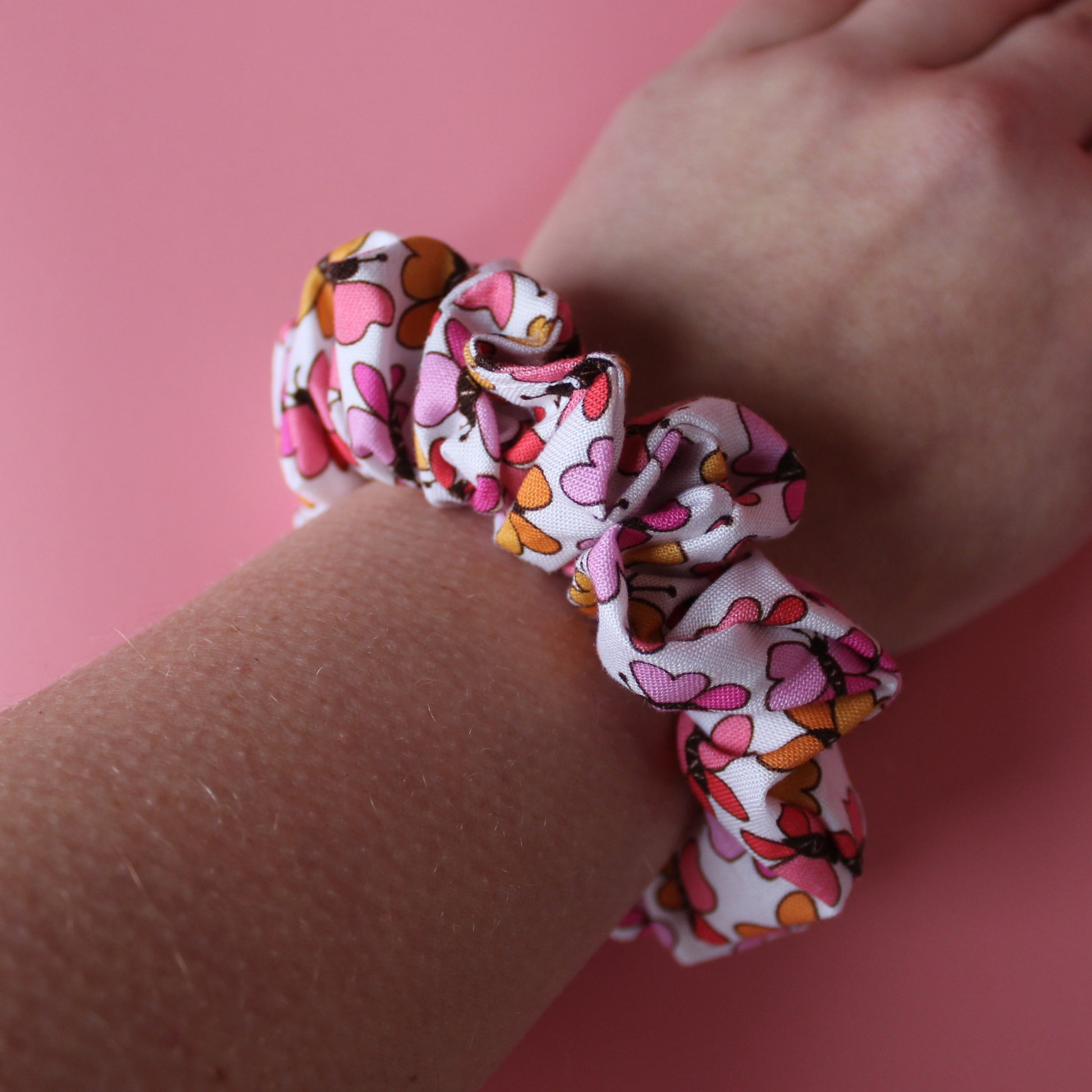 White scrunchie with bold pink and orange butterflies