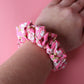 Pink floral hair scrunchie on wrist