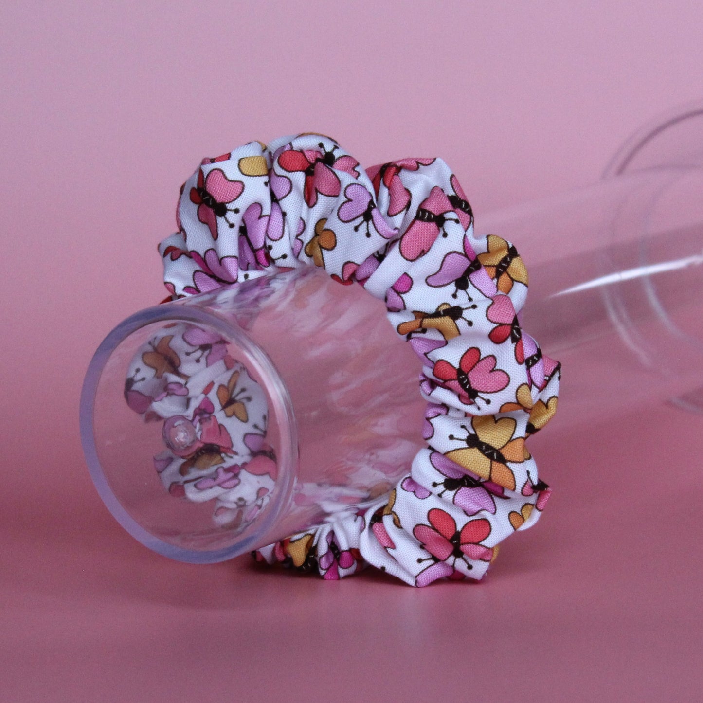 White scrunchie with bold pink and orange butterflies