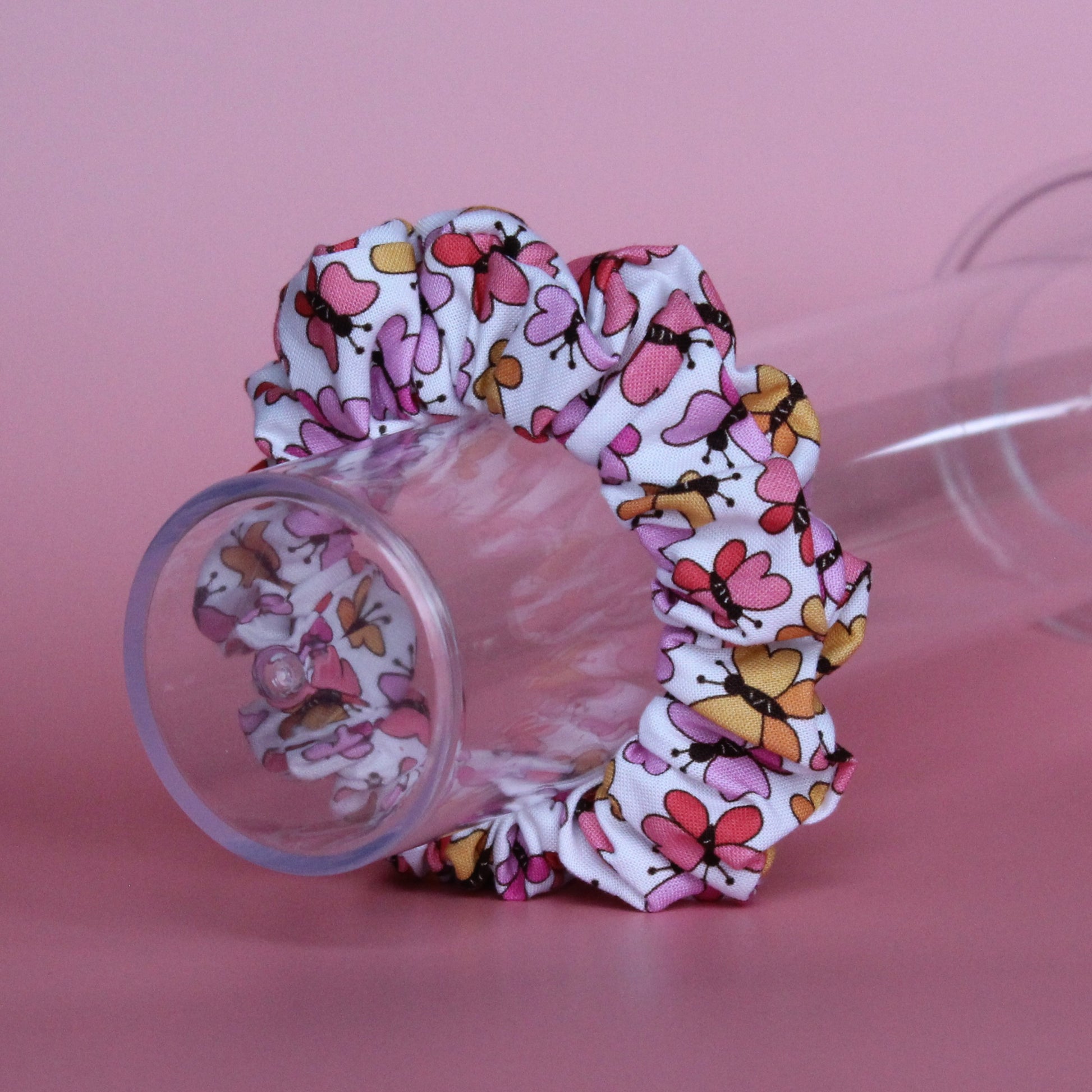 White scrunchie with bold pink and orange butterflies