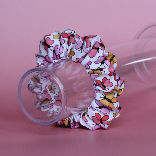 White scrunchie with bold pink and orange butterflies