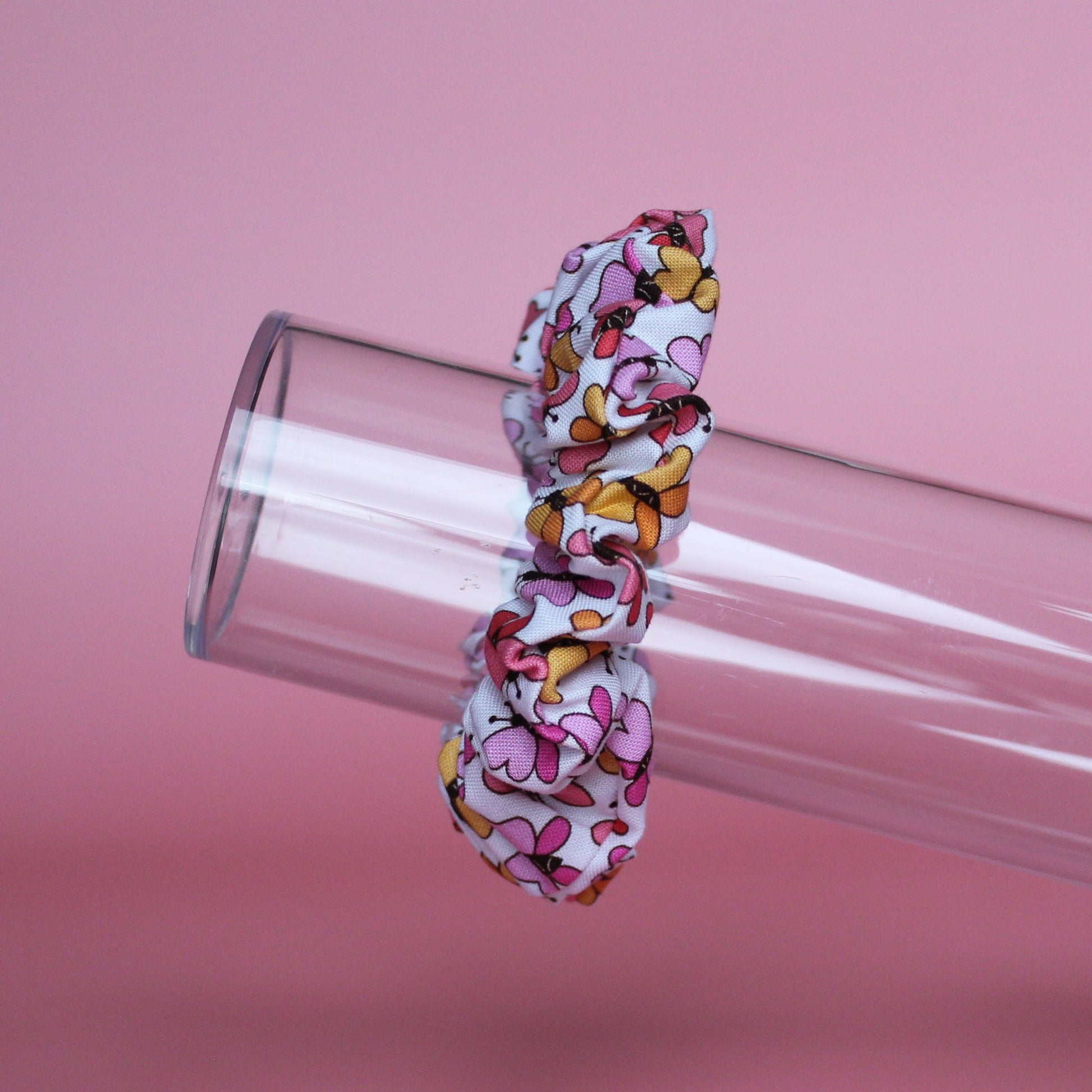 White scrunchie with bold pink and orange butterflies