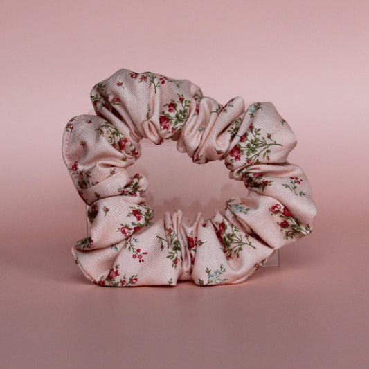 Pale pink scrunchie with subtle red small flowers