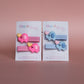 Two pairs of hair sliders - 1 pink with pink elephant embellishment and 1 blue
