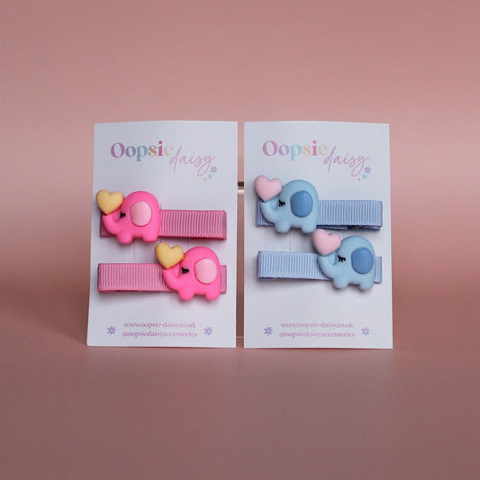 Two pairs of hair sliders - 1 pink with pink elephant embellishment and 1 blue