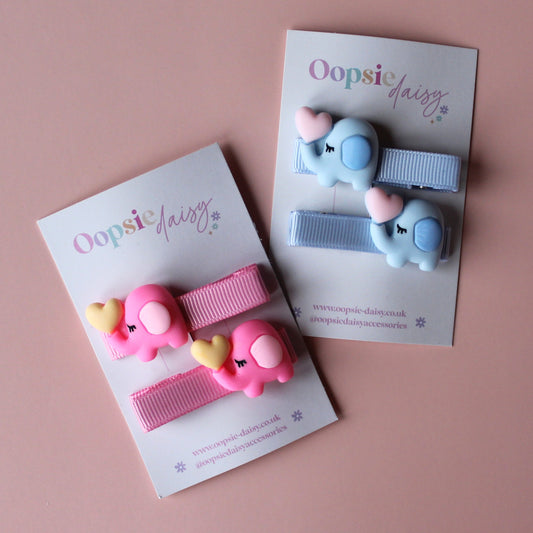 Two pairs of hair sliders - 1 pink with pink elephant embellishment and 1 blue