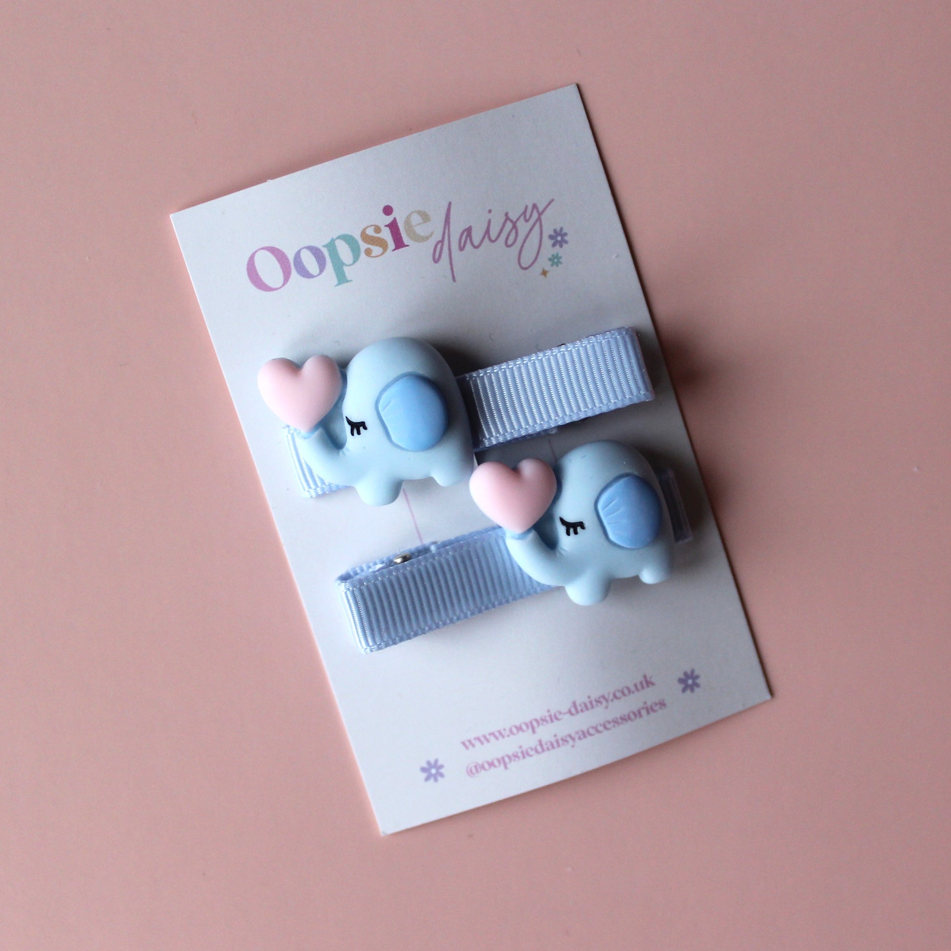 Light blue hair slider with light blue elephant embellishment with pink heart