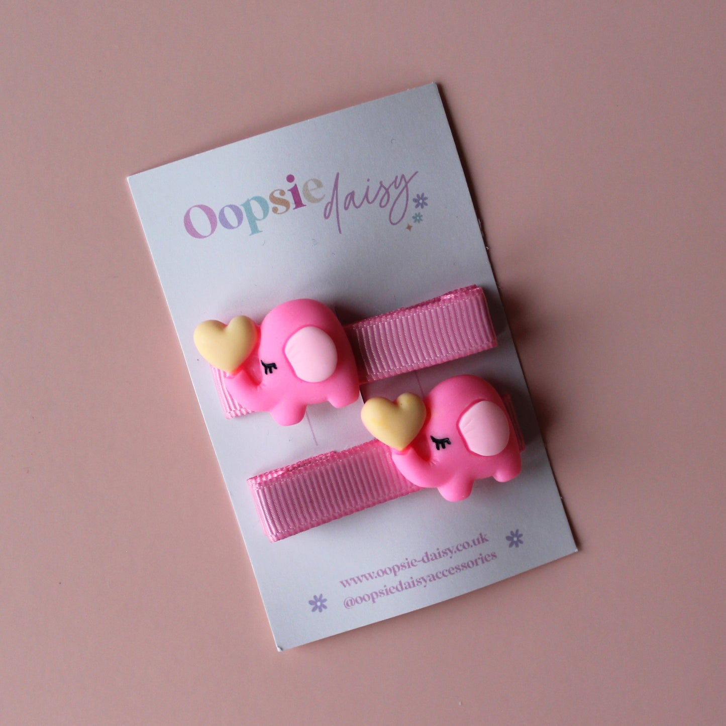 Pink hair slider with pink elephant embellishment with yellow heart