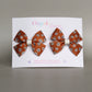 Pair orange hair bows with cream flowers