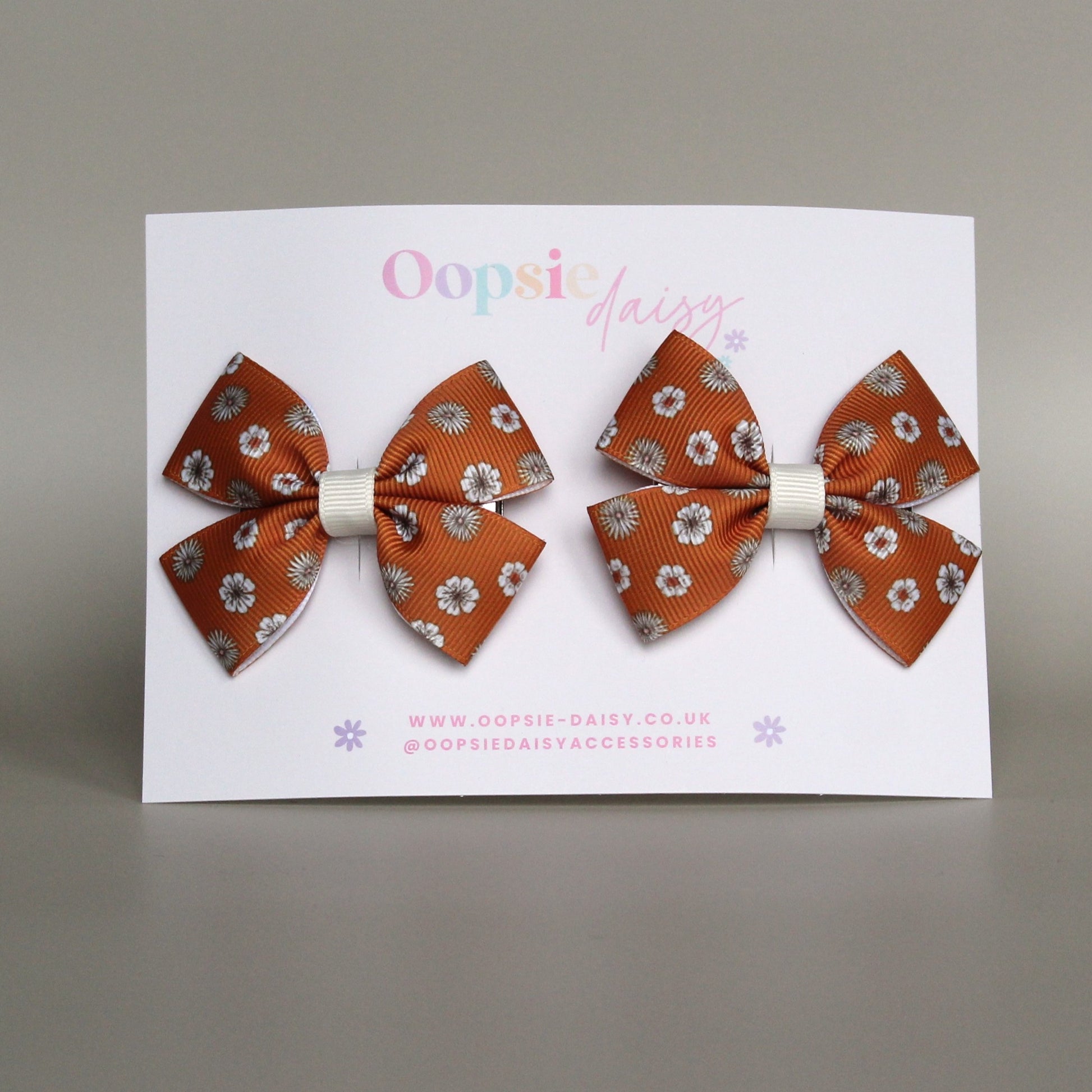 Pair orange hair bows with cream flowers