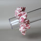 Oversized hair scrunchie with red heart pattern on neutral off-white background
