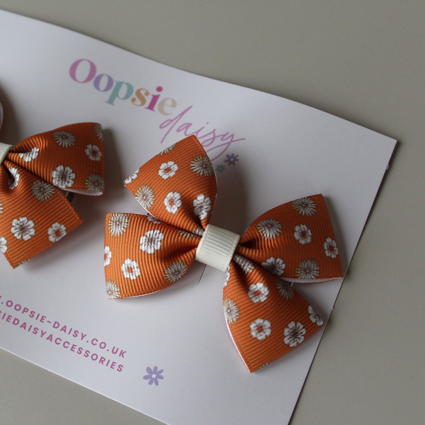 Pair orange hair bows with cream flowers