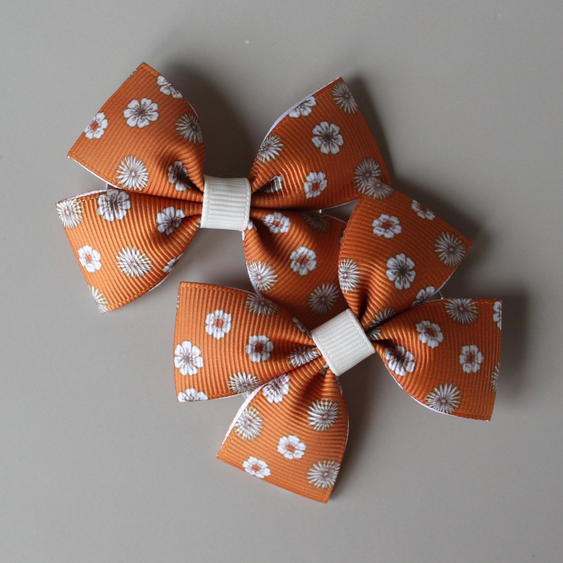 Pair orange hair bows with cream flowers