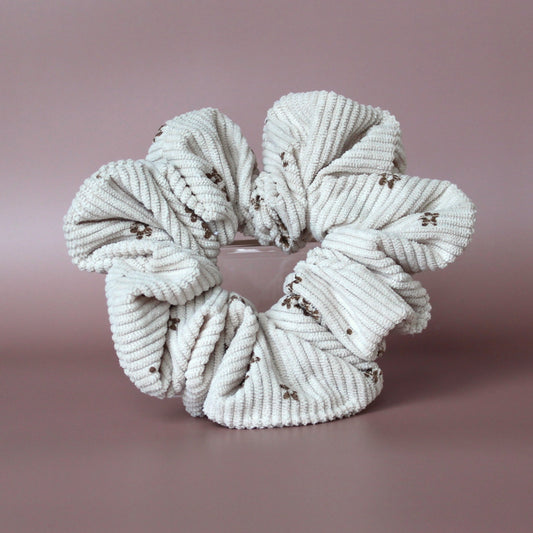Oversized scrunchie in beige corded fabric with small brown flowers
