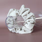 Oversized scrunchie in beige corded fabric with small brown flowers