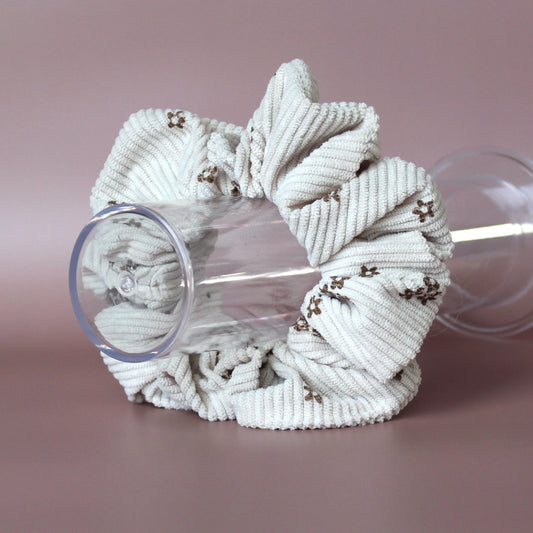 Oversized scrunchie in beige corded fabric with small brown flowers