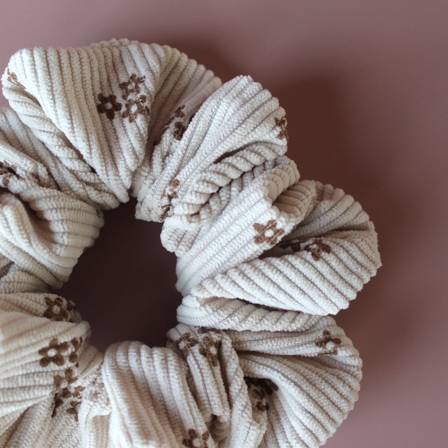 Oversized scrunchie in beige corded fabric with small brown flowers