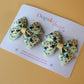 Green hair bows with cows and floral pattern