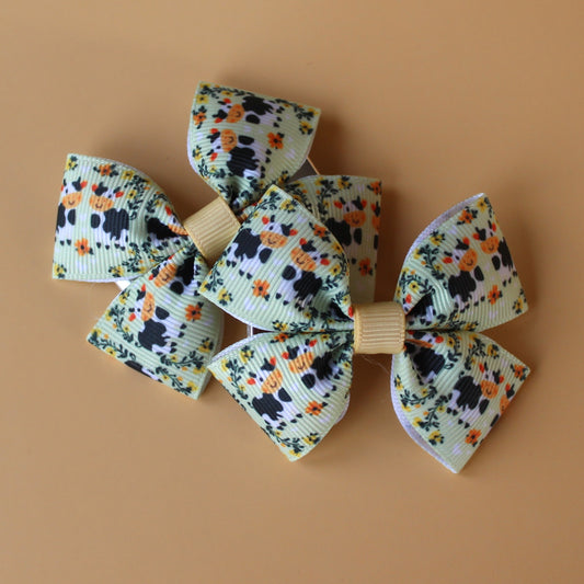Green hair bows with cows and floral pattern