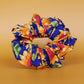 Oversized blue scrunchie with bold yellow and orange sunflowers