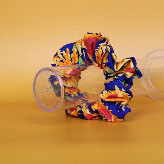 Oversized blue scrunchie with bold yellow and orange sunflowers