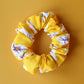 Yellow scrunchie with daisy flower pattern