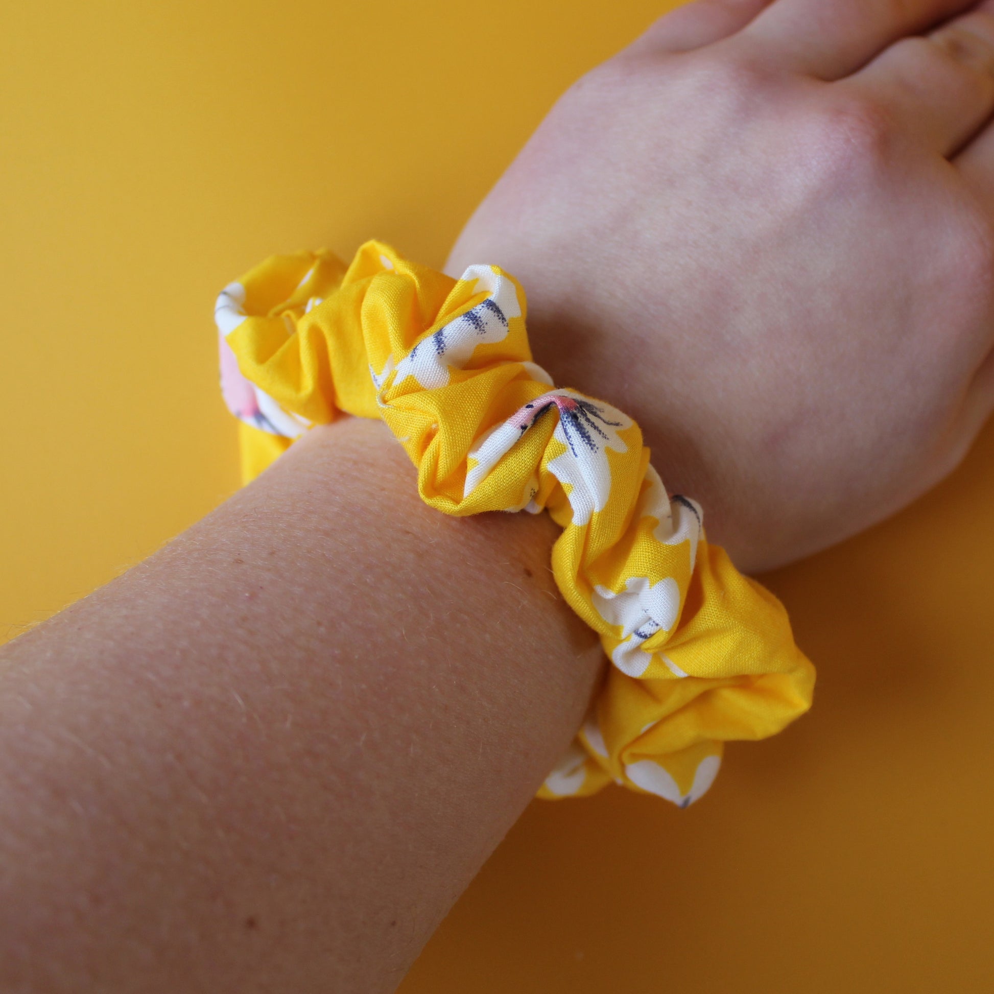 Yellow scrunchie with daisy flower pattern