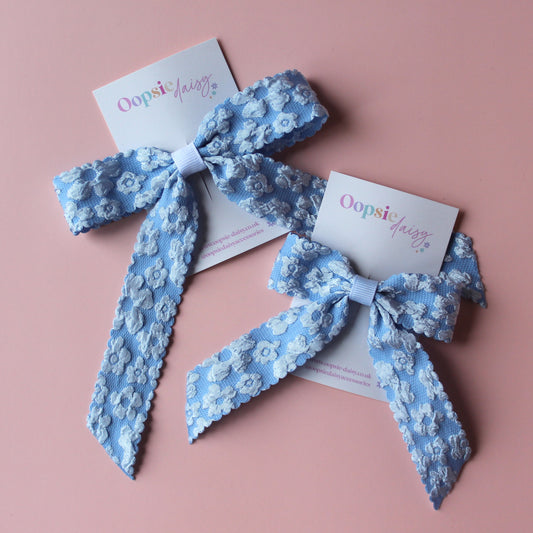 two skinny pale blue floral hair bows