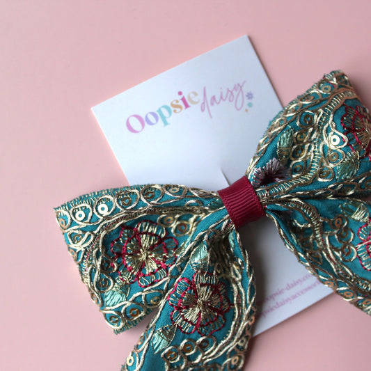 Teal hair bow with gold, pink and burgundy embroidered floral pattern with gold sequins