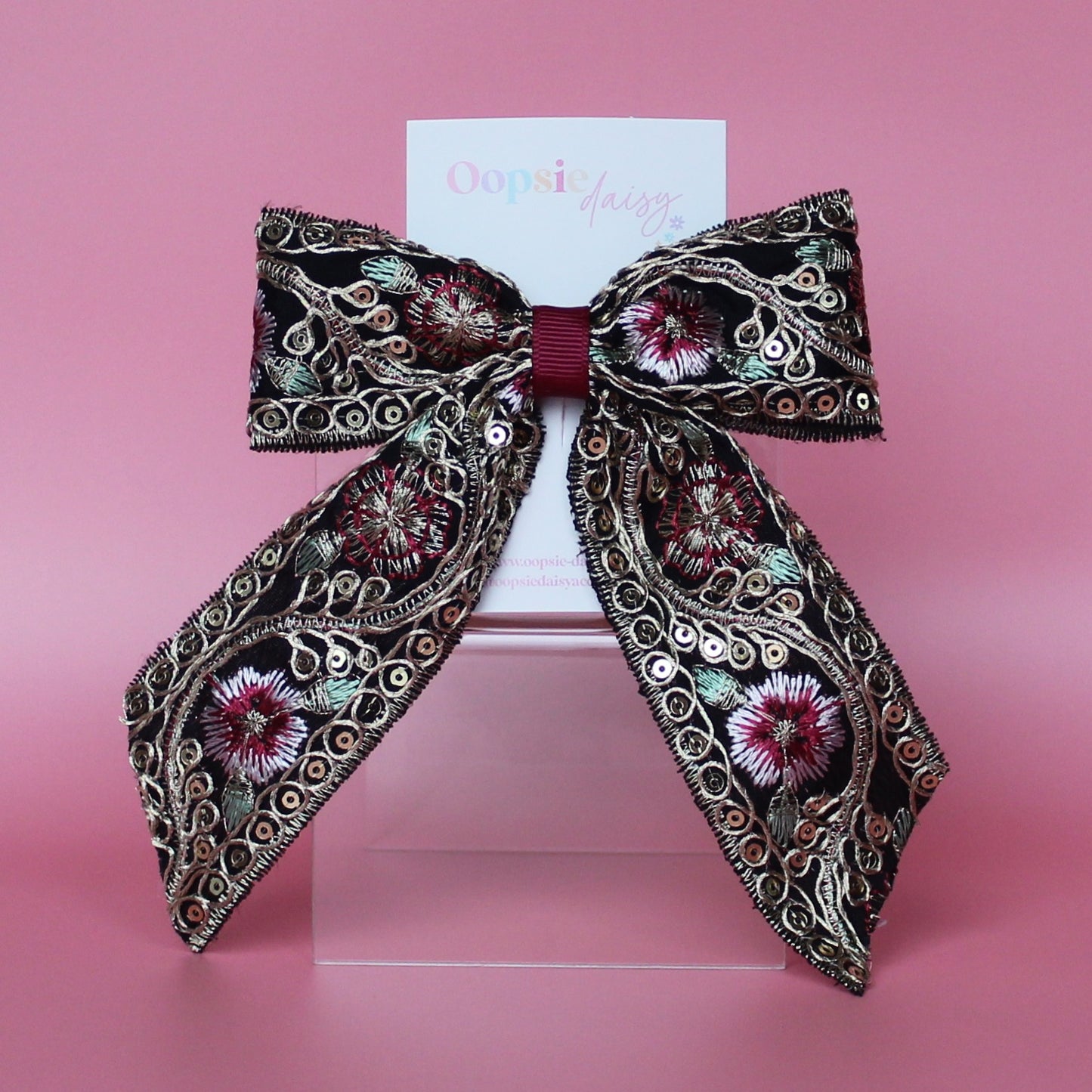 Black hair bow with gold and burgundy embroidered floral pattern