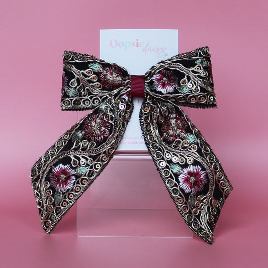Black hair bow with gold and burgundy embroidered floral pattern