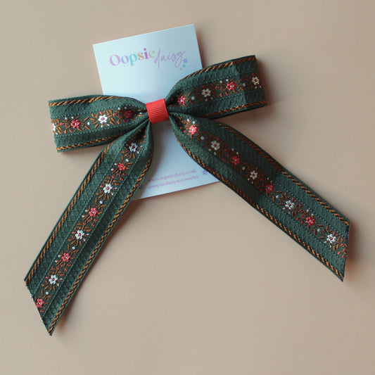 Khaki hair bow with rust orange and cream floral pattern