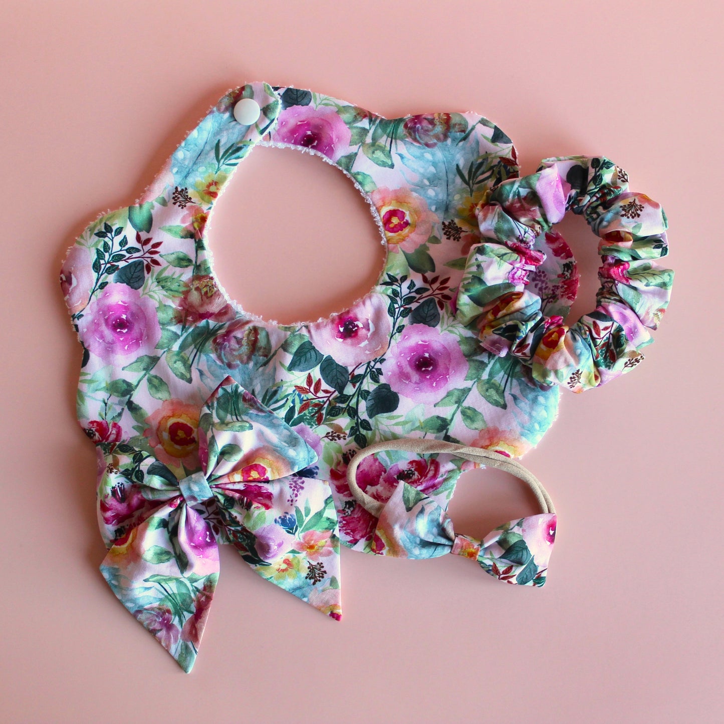 Pink and multicolour floral mum, baby and sister matching accessory set with scallop bib, scrunchie, hair bow and headband