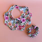 Pink and multicolour floral mum, baby and sister matching accessory set with scallop bib and scrunchie